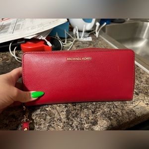 red michael kohrs wallet. plenty of space. leather material. only carried once.